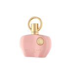 The image displays a perfume bottle from Afnan's "SUPREMACY" line. The bottle is made of smooth, matte pink glass and has a rounded, organic shape with a flat base, allowing it to stand upright. The cap is a glossy golden hue, designed with a loop that creates a visual focus and adds an element of luxury. On the front of the bottle is a golden emblem, adding a touch of elegance to the overall design. Below the emblem, in a simple and sophisticated font, reads "SUPREMACY AFNAN." 