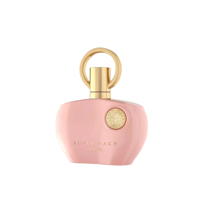 The image displays a perfume bottle from Afnan's "SUPREMACY" line. The bottle is made of smooth, matte pink glass and has a rounded, organic shape with a flat base, allowing it to stand upright. The cap is a glossy golden hue, designed with a loop that creates a visual focus and adds an element of luxury. On the front of the bottle is a golden emblem, adding a touch of elegance to the overall design. Below the emblem, in a simple and sophisticated font, reads "SUPREMACY AFNAN." 