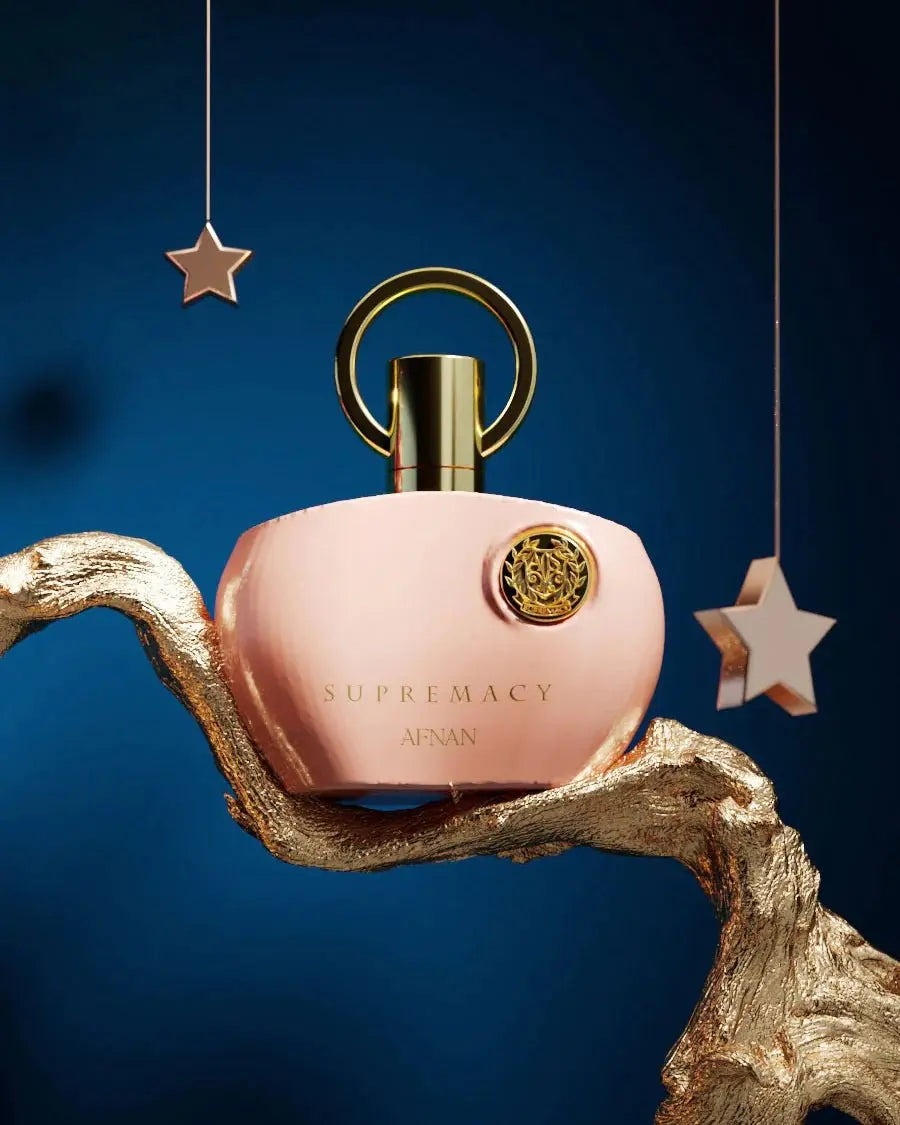 The image showcases a striking pink perfume bottle with a sleek and modern design. The bottle has a glossy finish, giving it a luxurious appearance. It features a cylindrical shape with a silver-toned cap that complements the overall aesthetic. The front of the bottle is adorned with a metallic emblem that adds a touch of elegance. The background is clean and white, allowing the perfume bottle to take center stage. The image exudes sophistication and quality, making it an appealing product presentation.