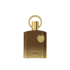 The image shows a luxurious perfume bottle with a sleek, modern design. The bottle appears to be made of a glossy, brown-gold glass with a golden cap that has a circular handle on top, giving it a unique and elegant look. The front of the bottle features a prominent emblem, likely a brand logo, embossed in gold which adds to the opulent aesthetic. Below the emblem, the words "SUPREMACY in Oud AFNAN" are printed in capital letters, indicating the fragrance name and brand. 