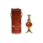 The image features an ornate perfume oil set, consisting of a cylindrical red container with gold trim and decorative elements, and a luxurious golden and red glass perfume oil bottle with an intricate metallic design. The container has a lid with two golden, braided rope-like handles and displays the text "Supreme AMBER" in a decorative golden font, with a smaller inscription "Concentrated Perfume Oil 20ml" below. 