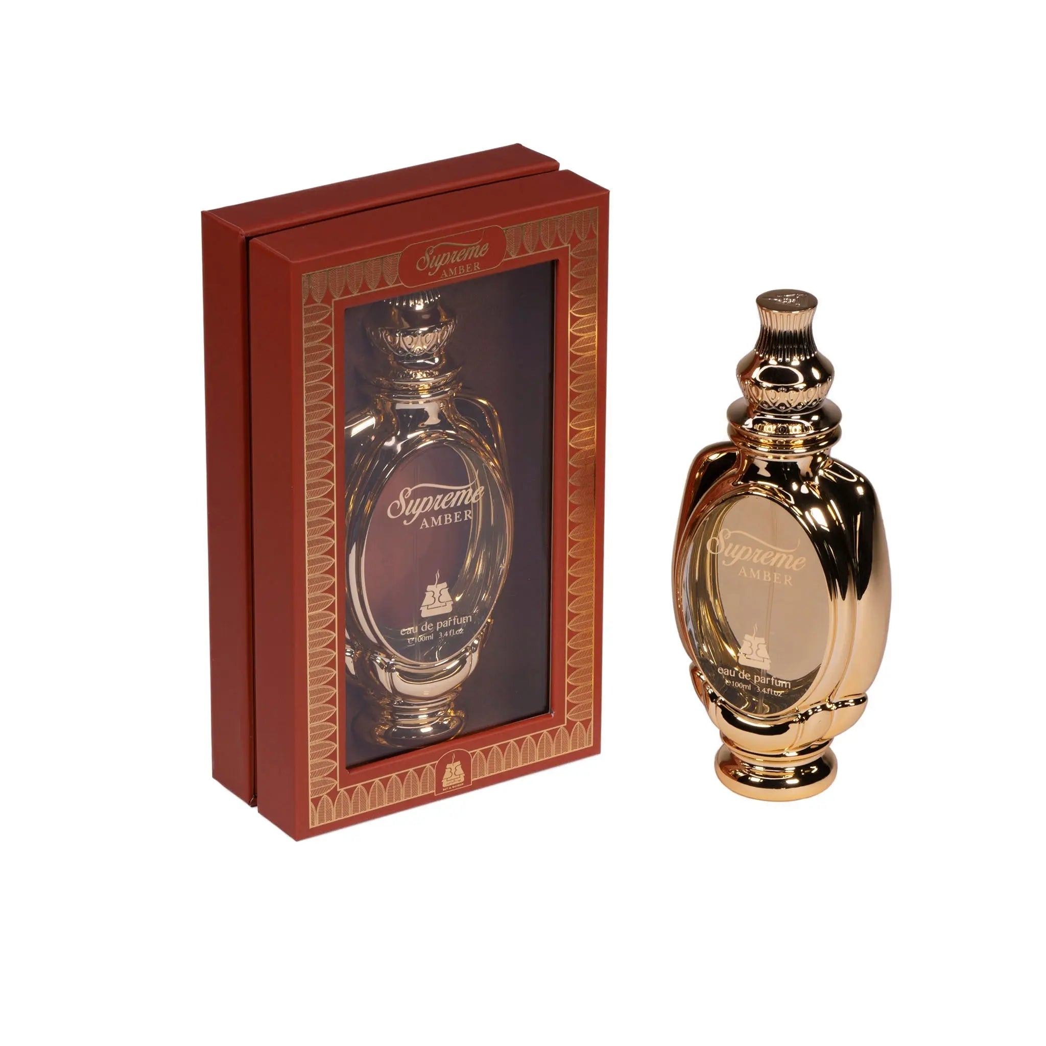The image showcases an elegant perfume set that includes a glossy, golden-brown perfume bottle and its packaging. The bottle has a classic, curvaceous form with a polished, reflective finish and a decorative cap featuring intricate patterns. Beside it, a rectangular red box with golden geometric and ornamental designs displays a clear window through which a similar perfume bottle is visible.