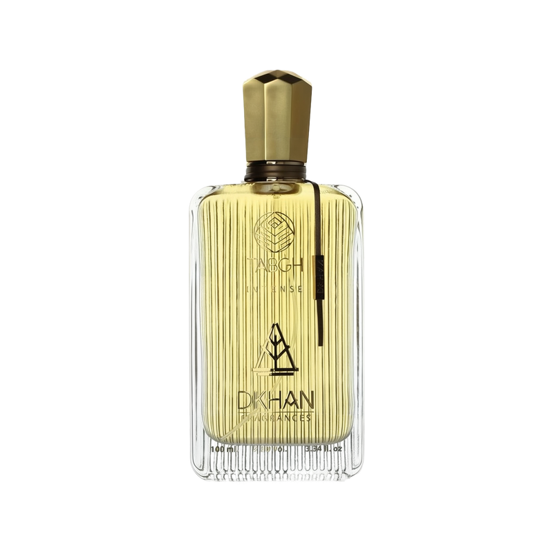 The image displays an elegant, clear glass perfume bottle with vertical ridges that create a textured effect. The liquid inside is a golden-yellow hue, evoking a sense of luxury and warmth. At the front of the bottle, the branding "TABGH INTENSE" is written in a sophisticated font, with the emblem "DKHAN FRAGRANCES" placed just below. A unique gold-colored cap tops the bottle, and there is a black vertical label on the right side with additional branding or fragrance information.