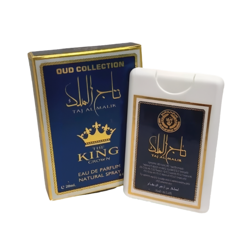 The image features two items from the "OUD COLLECTION." On the left is a dark blue box with gold lettering and detailing; it displays the name "TAJ AL MALIK" in both Arabic calligraphy and English, along with "THE KING CROWN" beneath it. The text "EAU DE PARFUM NATURAL SPRAY 20ml." is also visible. On the right is a white plastic case with a label that mirrors the box's design, holding the perfume inside.