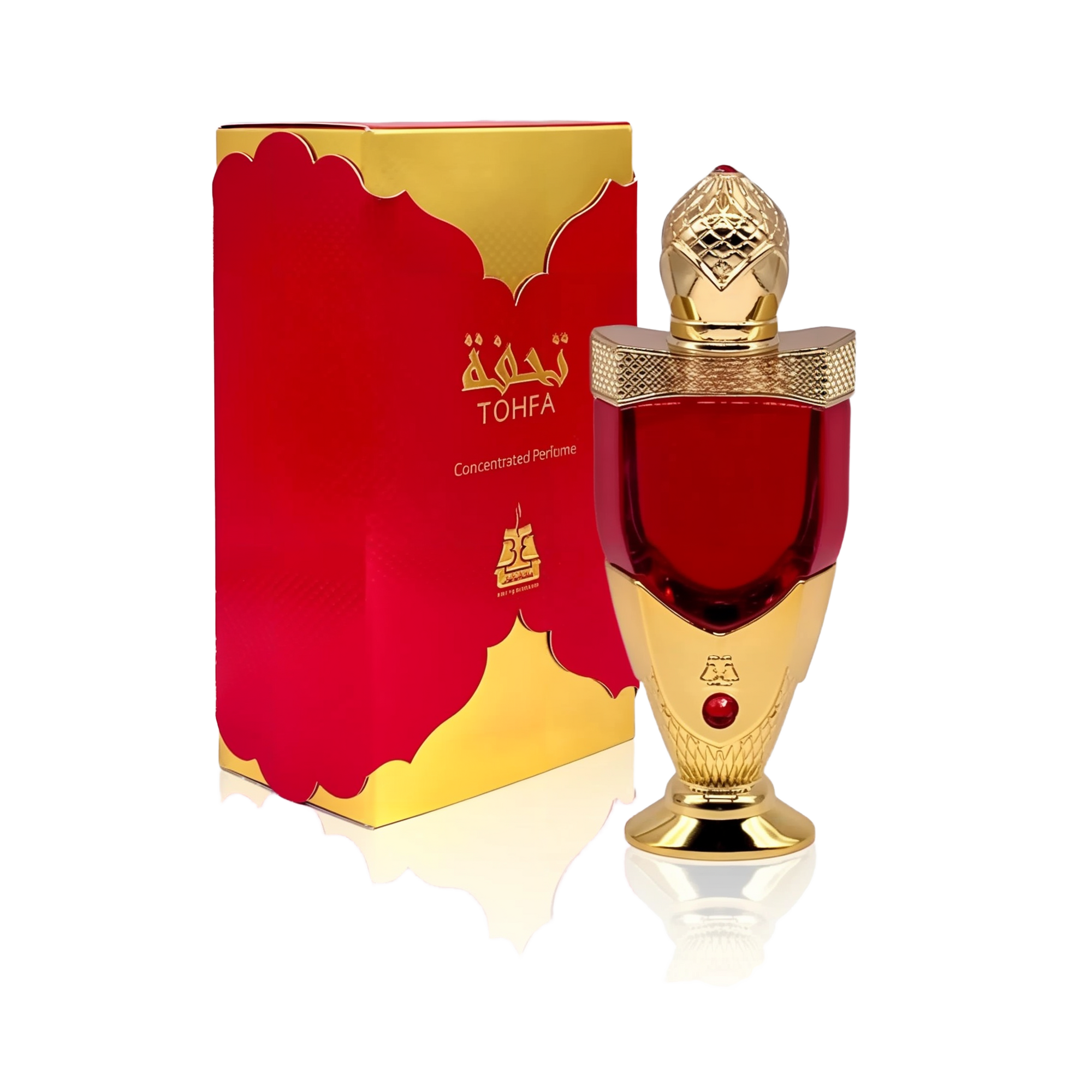 The image shows a luxurious perfume bottle next to its packaging. The bottle has a rich red color with a golden cap, detailed with intricate patterns and topped with a clear faceted finial that resembles a gem. The base and neck of the bottle also feature golden accents. A red gem is embedded in the golden section of the bottle. The packaging box is red with a golden border and carries the brand name "TOHFA" in gold lettering.
