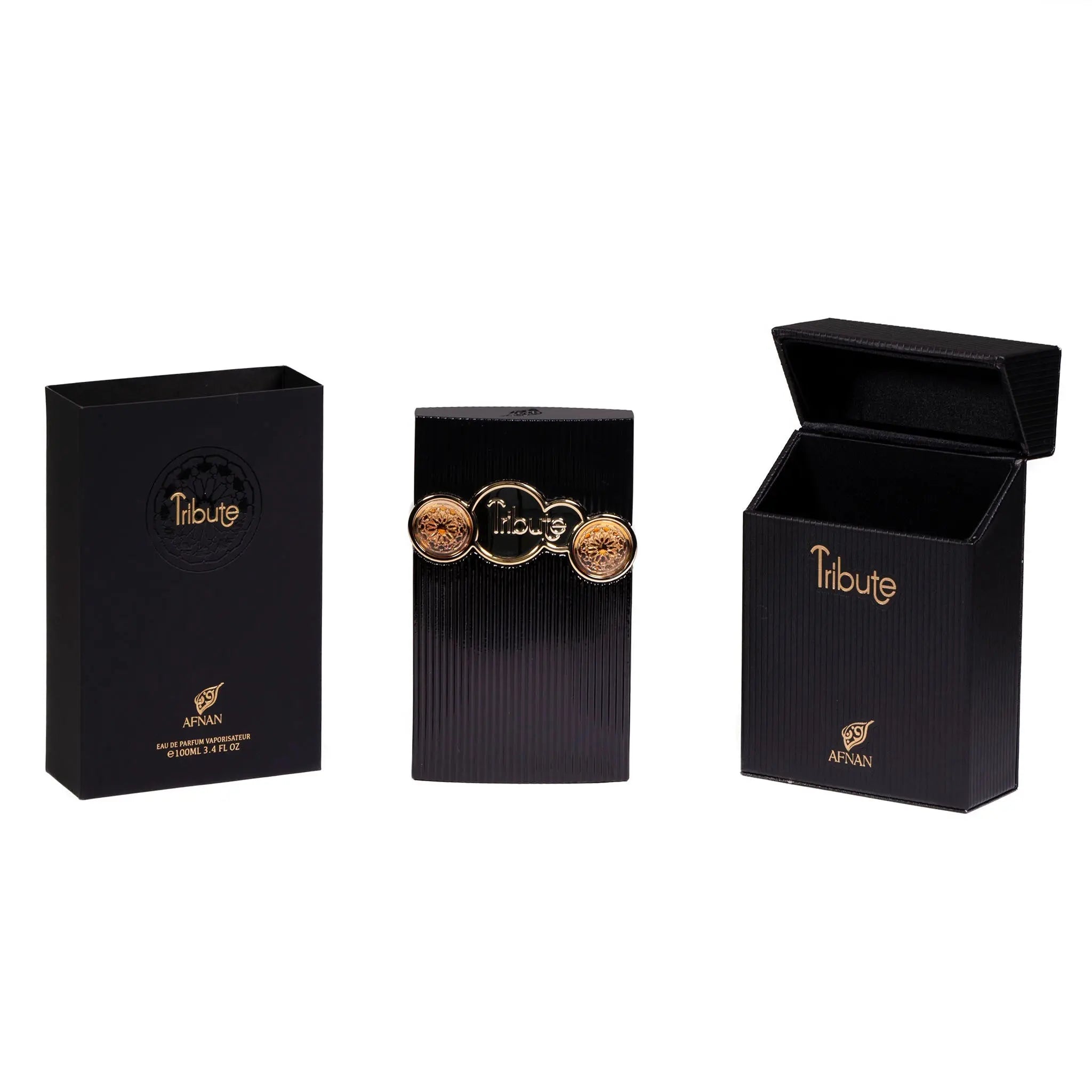 The image features a three-piece set from the perfume brand "AFNAN". On the left is a sleek black packaging box with a gold embossed circular emblem that reads "Tribute" and the AFNAN logo beneath it. In the middle stands the perfume bottle, which has a ribbed black surface and is adorned with three ornate gold seals.  To the right, there is another black box, this one open to display the interior, with "Tribute" and the AFNAN logo again in gold lettering.