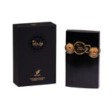 The image features a perfume product set including a box and the perfume bottle itself. The packaging box is black with the brand's name "AFNAN" and the product name "Tribute" in elegant gold lettering, along with an ornate circular design featuring the same text.  The perfume bottle has a tall, ribbed black body with three decorative gold seals arranged horizontally across the center. Each seal bears the name "Tribute" and a detailed emblem, which gives the bottle a regal and sophisticated appearance. 