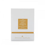 The image shows a white packaging box with a gold-colored label for a fragrance product. The label contains the name "VANILLA MUSK" in English and Arabic script, followed by "IBRAHEEM AL.QURASHI SPECIAL KHAMRIYA FOR HAIR." A gold strip at the base of the box complements the label, and the brand's logo is discreetly positioned at the bottom. 