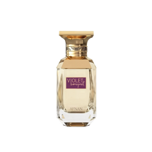 The image displays a perfume bottle with a clear glass and gold accents. The bottle has a geometric shape with a multi-faceted base, creating a crystal-like appearance. The cap is gold with a decorative band that features a braided pattern. A purple label on the bottle reads "VIOLET BOUQUET" in white uppercase letters, and the brand name "AFNAN" is displayed at the bottom of the label in smaller text. 