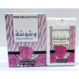 The image shows a perfume product named "Washwashah" from the Oud Collection by Ard Al Zaafaran. The packaging box features a pink and white wavy pattern with illustrations of roses at the bottom. The product name "Washwashah" is displayed in both Arabic and English in the center of the box.