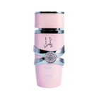 This image depicts a cylindrical, pale pink perfume bottle with the name "YARA" from the brand Lattafa. The bottle has a unique stacked design with silver bands wrapping around it, giving the appearance of three separate sections. The upper and lower sections are matte pink, while the middle section is glossy black, providing a striking contrast. A silver emblem with intricate detailing is centered on the middle band. The Arabic script, likely the name "YARA," is printed in black on the upper pink section.