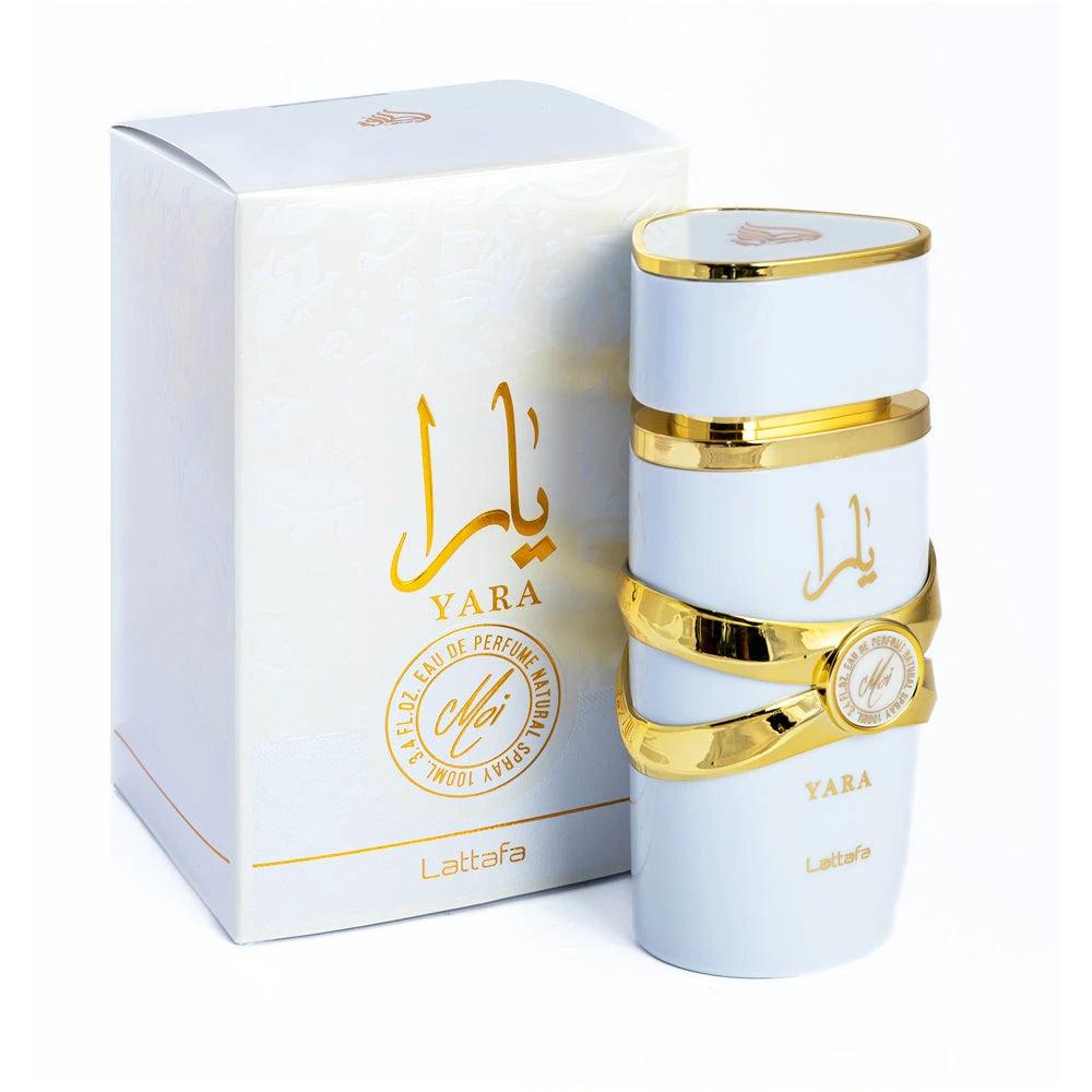 The image shows a cylindrical perfume bottle for "YARA Moi" by Lattafa, accompanied by its packaging. The bottle is matte white with gold bands and features the brand name "Lattafa" at the bottom. It has a ribbon-like gold band around its center with a ro