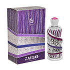 A decorative perfume bottle next to its packaging box. The bottle has a silver and purple design with silver filigree and purple enamel stripes, topped with a silver crown-like cap and a pink crystal. The box features a matching purple and white color sch