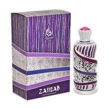 A decorative perfume bottle next to its packaging box. The bottle has a silver and purple design with silver filigree and purple enamel stripes, topped with a silver crown-like cap and a pink crystal. The box features a matching purple and white color sch