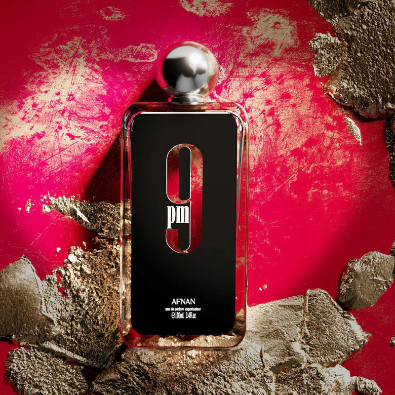 Afnan 9PM men’s eau de parfum 100 ml bottle on vivid red background with textured gold accents