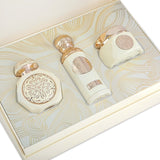 The image displays a set of Gissah "Endless Love" perfume bottles arranged inside an elegant cream-colored presentation box with gold line art patterns. The box contains three bottles, each with a unique shape and ornate gold detailing: a rounded cap on a cylindrical bottle, a flat cap on a wide bottle, and a cube-shaped bottle with a gold medallion on the front. Each bottle bears the Gissah emblem, and the design elements are reminiscent of luxury and classic beauty.