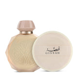 Gissah beige perfume bottle with matching cap beside round cream lid with logo on white background.