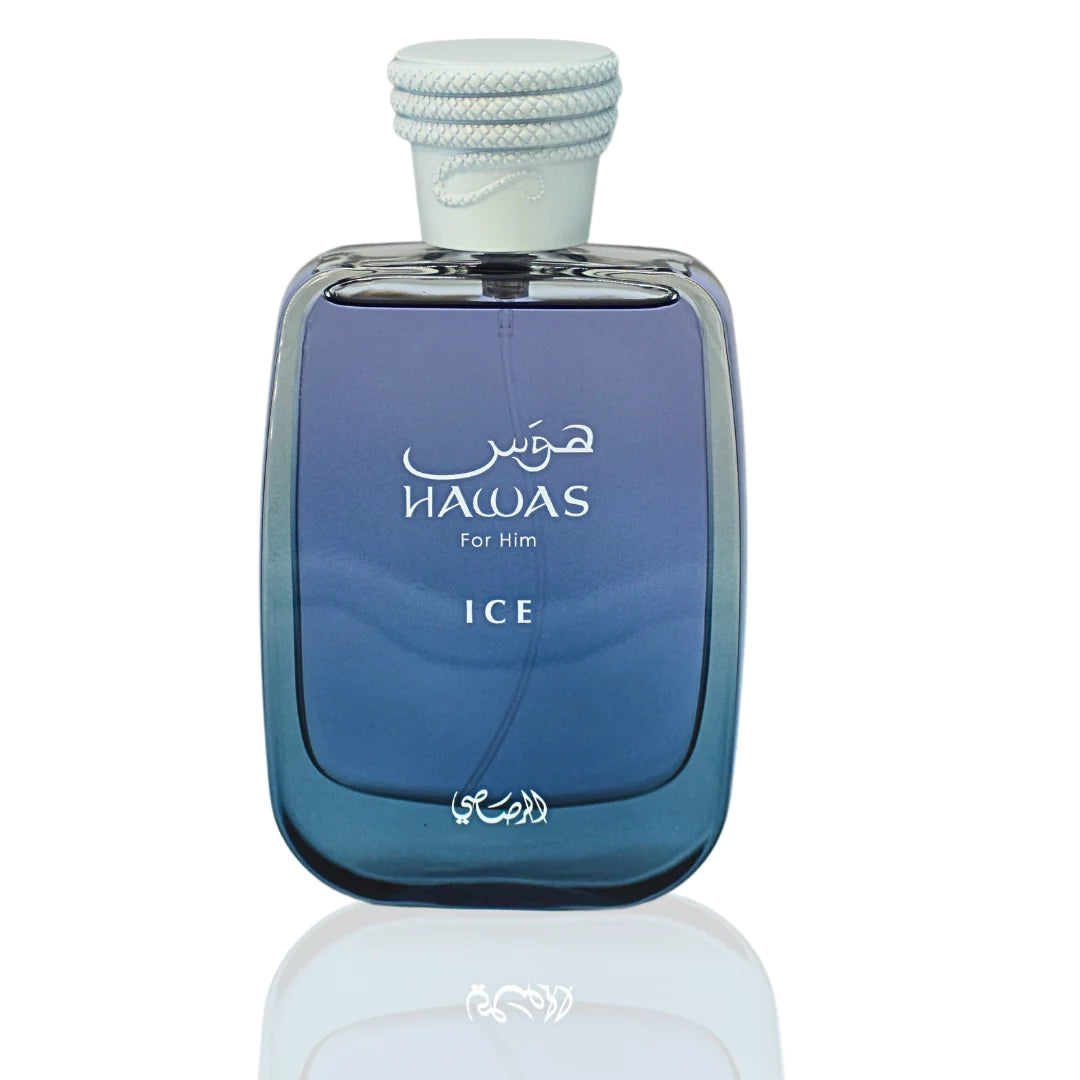 The image displays a perfume bottle named HAWAS ICE For Him. The bottle has a sleek, rectangular shape with rounded edges and a gradient design transitioning from transparent to a deep blue color, suggesting a cool or icy theme. It features white text with the product name and "For Him" both in English and Arabic script. The cap is textured and white, with a rope-like detail wrapped around it, enhancing the nautical or fresh theme of the product.