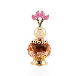 The image features a luxurious perfume bottle from Khadlaj called Pink Musk. The bottle is a decorative orb with a transparent amber body and intricate gold filigree details, including floral motifs with pink and purple crystal embellishments. The cap is a stylized design with three pink petal-shaped crystals, evoking the image of a flower or tulip. The perfume's name and the brand "Khadlaj" are inscribed on the golden neck of the bottle.