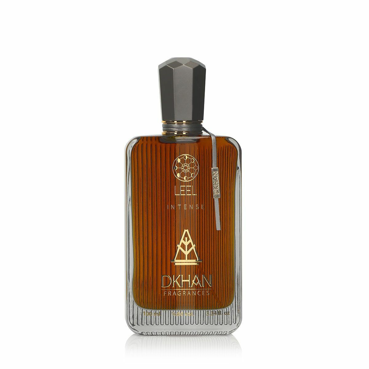 The image features a sleek glass perfume bottle with a rich, amber-hued liquid inside. The front of the bottle displays the word "LEEL" in large, bold letters, with "INTENSE" just beneath it in a smaller font. Below this, the "DKHAN FRAGRANCES" emblem is prominently centered. At the top of the bottle, a golden geometric design is visible. The cap is a faceted black design, suggesting a luxurious and modern aesthetic. 