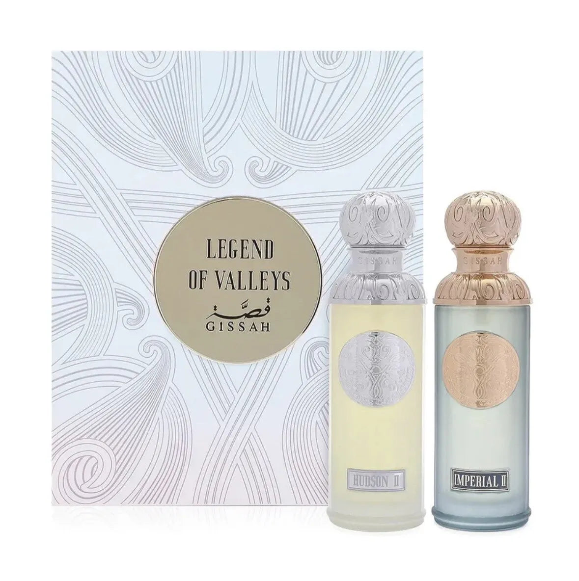 The image features two perfume bottles from the "Legend of Valleys" collection by Gissah. In the background is the collection's packaging, a white box with a swirling line pattern and a circular gold label that reads "Legend of Valleys Gissah." In front of the box are the perfume bottles "Hudson II" with a light yellow tint and "Imperial II" with a light blue tint. Both bottles have ornate silver caps and medallions that match the color of the glass.